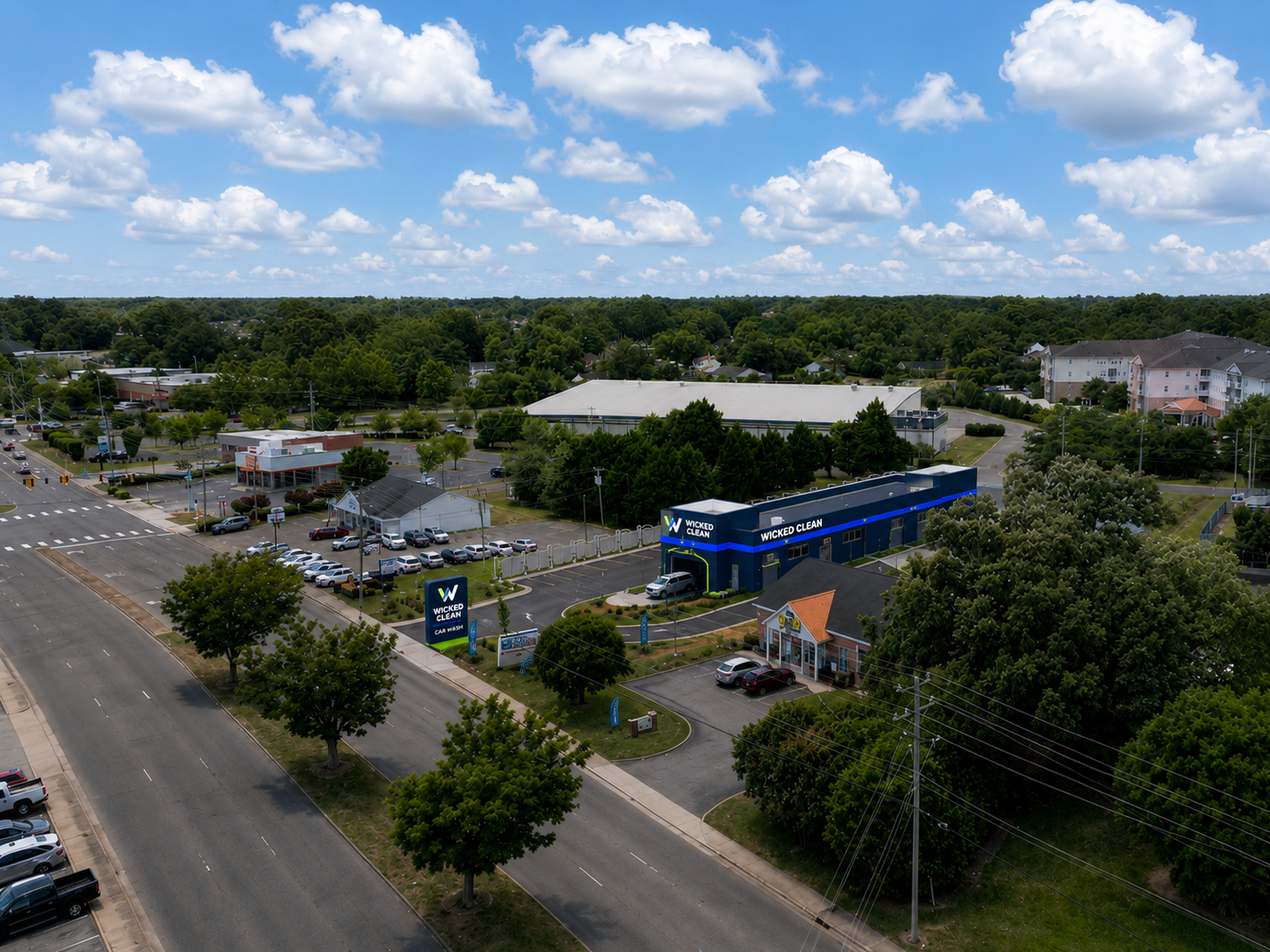 Overhead view of the Wicked Clean site concept with illuminated wash lane and vacuum area.